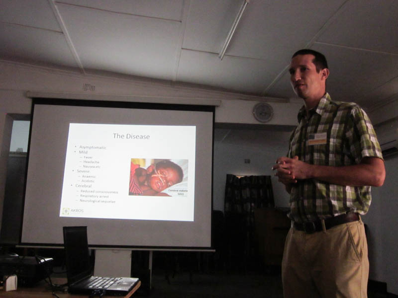 Akros Director of Research, Daniel Bridges, gives a slide presentation on malaria to around 40 students from Lusaka Community International School.