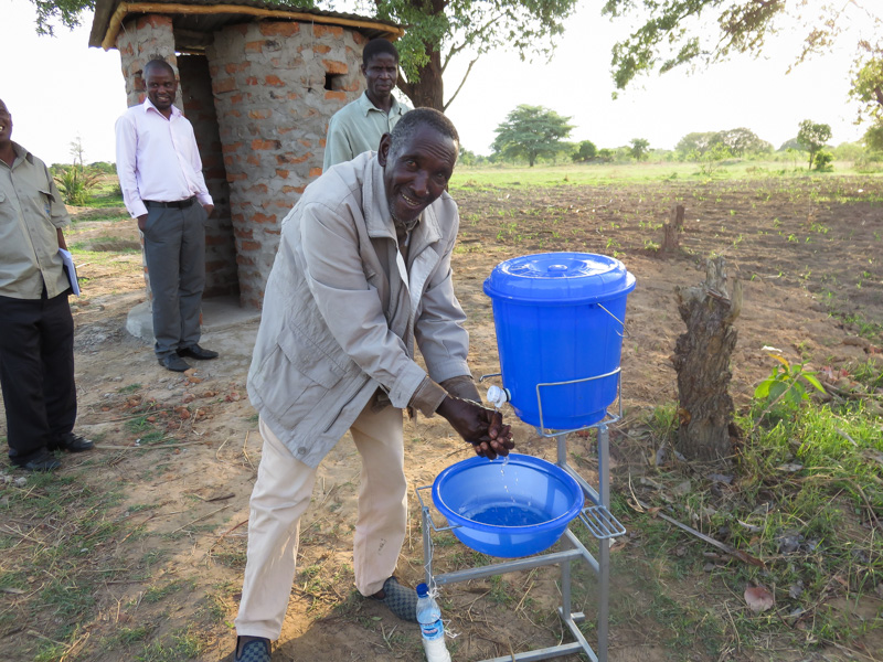 A man uses a hand washing facility, one of the CLTS tools promoted by Chief Mukobela.