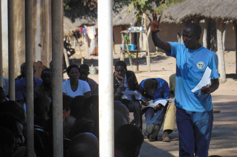 Community Champion Chris Malambo teaches community-led total sanitation.