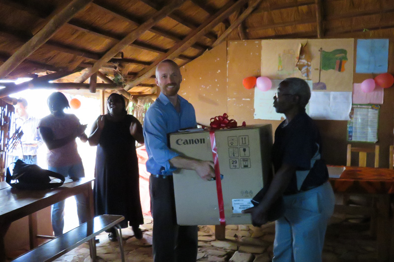 Akros Country Director, Ben Winters, presents Mercy Ministries with a copy/printer, a welcome Christmas gift for the organization.