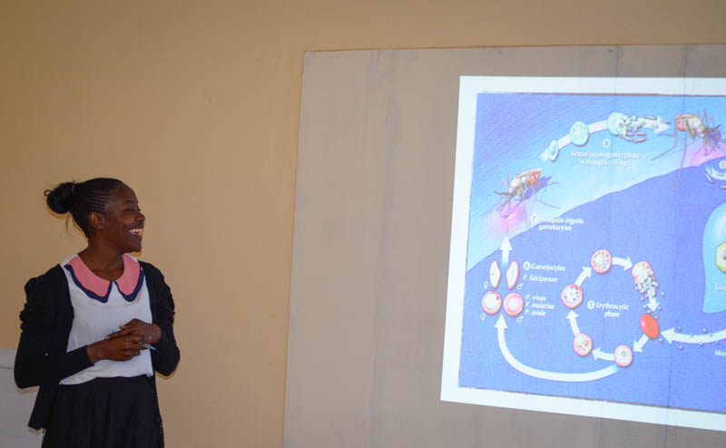Mulenga Mwenda, the Laboratory Technologist, Akros Laboratory Technologist, gives a presentation on malaria and its cycle.